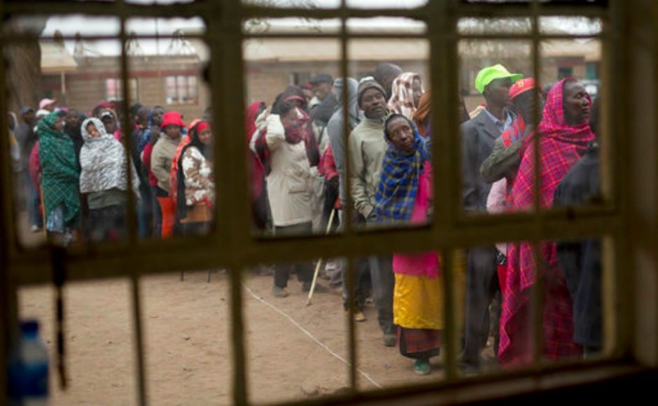 Kenyans line up to vote in Bissil , 120 km south of Nairobi, Kenya,Tuesday, Aug. 8, 2017. Kenyans are going to the polls to vote in a general election after a tightly-fought presidential race between incumbent President Uhuru Kenyatta and main opposition leader Raila Odinga. (AP Photo/Jerome Delay)