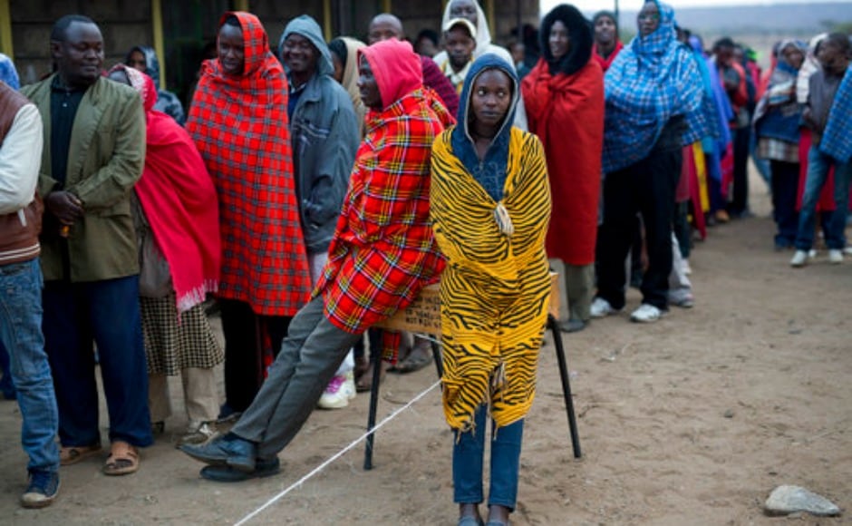 Kenyans line up to vote in Bissil , 120 km south of Nairobi, Kenya,Tuesday, Aug. 8, 2017. Kenyans are going to the polls to vote in a general election after a tightly-fought presidential race between incumbent President Uhuru Kenyatta and main opposition leader Raila Odinga. (AP Photo/Jerome Delay)
