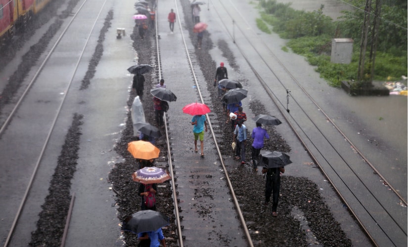 Having waited for hours on end with water showing no signs of receding, fidgety passengers were seen jumping off stationary trains and walking along the tracks to their destinations. Reuters Having waited for hours on end with water showing no signs of receding, fidgety passengers were seen jumping off stationary trains and walking along the tracks to their destinations. Reuters