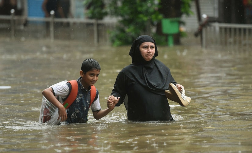 People's woes were compounded by the high tide that prevented natural drainage of water into the sea. PTI People's woes were compounded by the high tide that prevented natural drainage of water into the sea. PTI