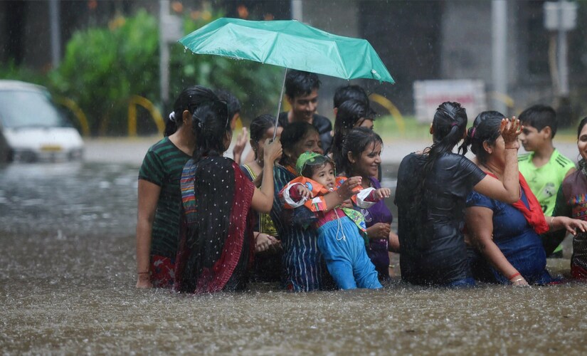 Commuters were seen standing under knee deep water on the steps of buses in low lying areas like Parel. Traffic crawled at snail's pace on important roads, including the Eastern and Western Express Highway, Sion-Panvel highway and LBS Marg. PTI Commuters were seen standing under knee deep water on the steps of buses in low lying areas like Parel. Traffic crawled at snail's pace on important roads, including the Eastern and Western Express Highway, Sion-Panvel highway and LBS Marg. PTI