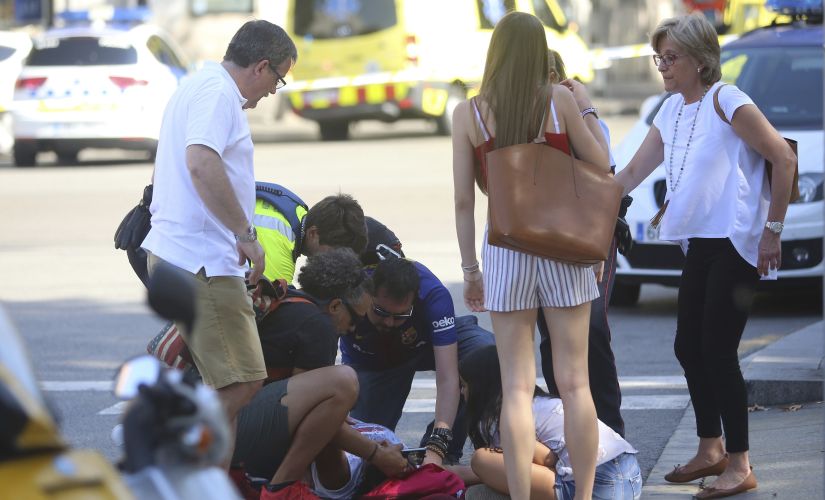 Paramedics treat an injured person after Thursday's terror attack in Barcelona. AP