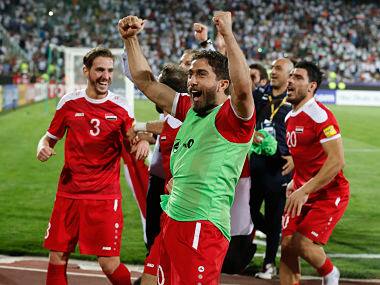 Syria's players celebrate at the end of their FIFA World Cup 2018 qualification football match against Iran at the Azadi Stadium in Tehran on September 5, 2017. / AFP PHOTO / ATTA KENARE
