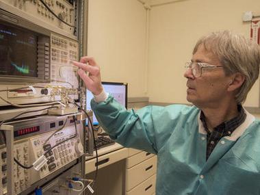 NIST physicist Ward Johnson observes signals generated by bacteria coating quartz crystals. NIST