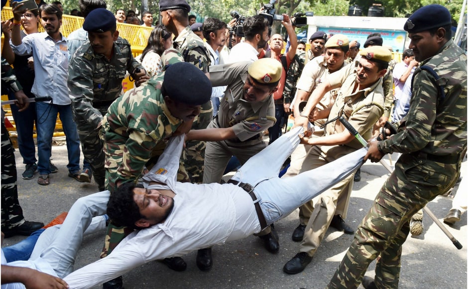 Delhi Police detained several students who tried to jump the barricades put up at Shastri Bhawan . PTI Delhi Police detained several students who tried to jump the barricades put up at Shastri Bhawan . PTI