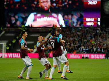 West Ham’s Andre Ayew celebrates with teammates after scoring his side’s second goal during the match against Huddersfield Town. AP 