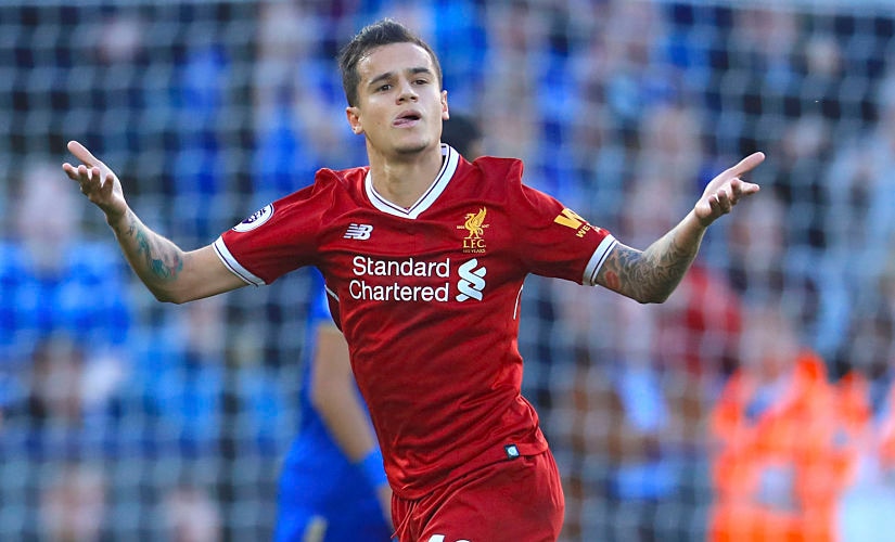 Liverpool's Philippe Coutinho, left, celebrates scoring his side's second goal of the game during the Premier League soccer match. Leicester City versus Liverpool at the King Power Stadium, Leicester, England, Saturday Sept. 23, 2017. (Mike Egerton/PA via AP)