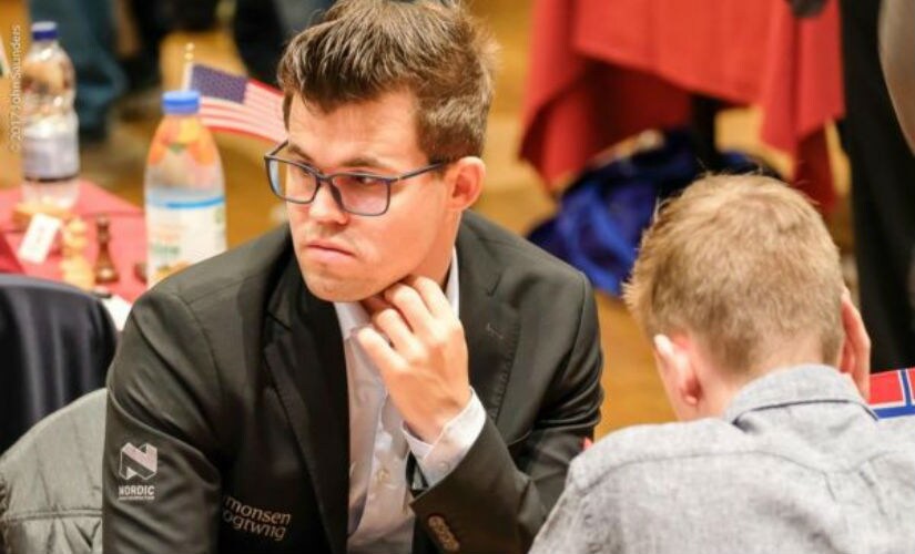 When you're the world champion, you don't even have to look at the board to win! Magnus Carlsen at the event. John Saunders