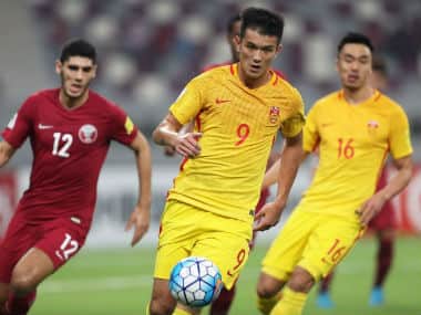 China’s Xiao Zhi (centre) controls the ball during the match against Qatar. AFP 