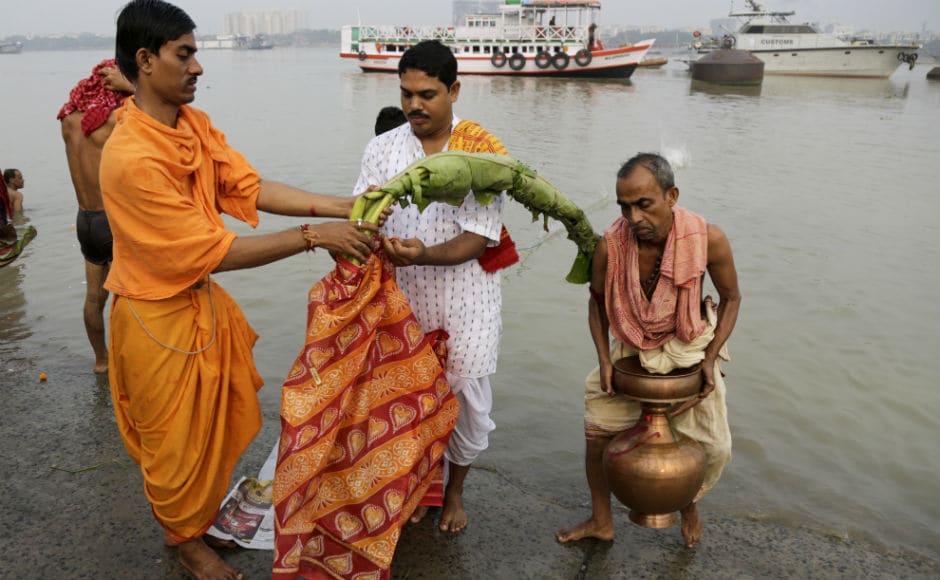 As per the custom, devotees dipped a banana sapling in the river Ganga and draping it with a sari, symbolising goddess Durga’s first day at her ancestral home. This was followed by long and elaborate rituals of the puja, which ended with floral offerings to the goddess. AP As per the custom, devotees dipped a banana sapling in the river Ganga and draping it with a sari, symbolising goddess Durga’s first day at her ancestral home. This was followed by long and elaborate rituals of the puja, which ended with floral offerings to the goddess. AP