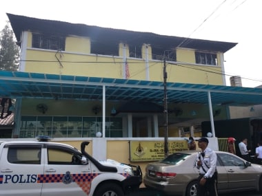 Police and fire department work at the religious school after a fire broke out in Kuala Lumpur, Malaysia. Reuters