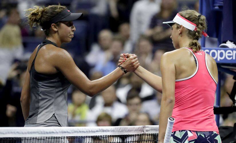 Madison Keys, left, of the United States, shakes hands with Elise Mertens, of Belgium, after Keys won their match at the U.S. Open tennis tournament, Tuesday, Aug. 29, 2017, in New York. (AP Photo/Julio Cortez)