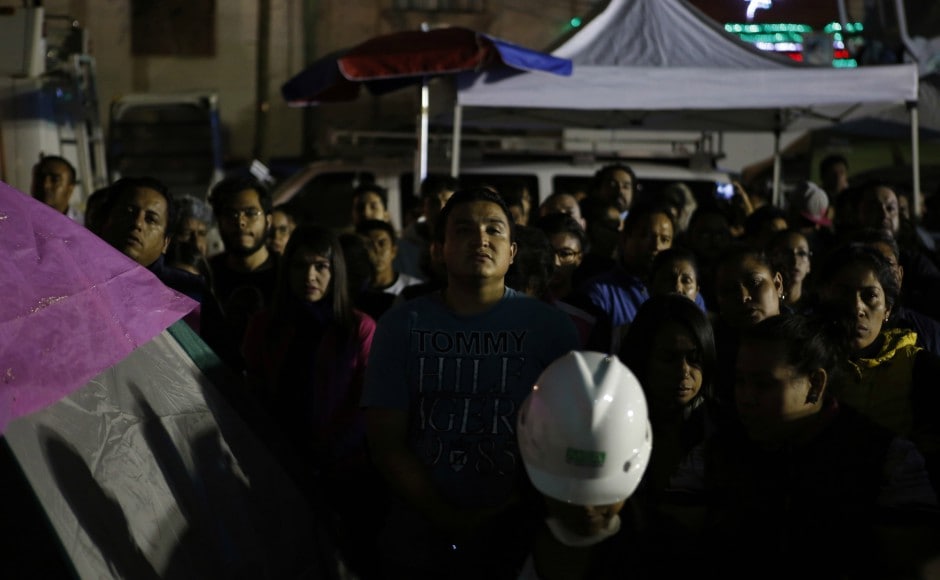 Onlookers stand in the street after midnight watching rescuers search for survivors inside a collapsed office building in Mexico City. The powerful 7.1-magnitude earthquake on Wednesday killed at least 272 people. AP Onlookers stand in the street after midnight watching rescuers search for survivors inside a collapsed office building in Mexico City. The powerful 7.1-magnitude earthquake on Wednesday killed at least 272 people. AP