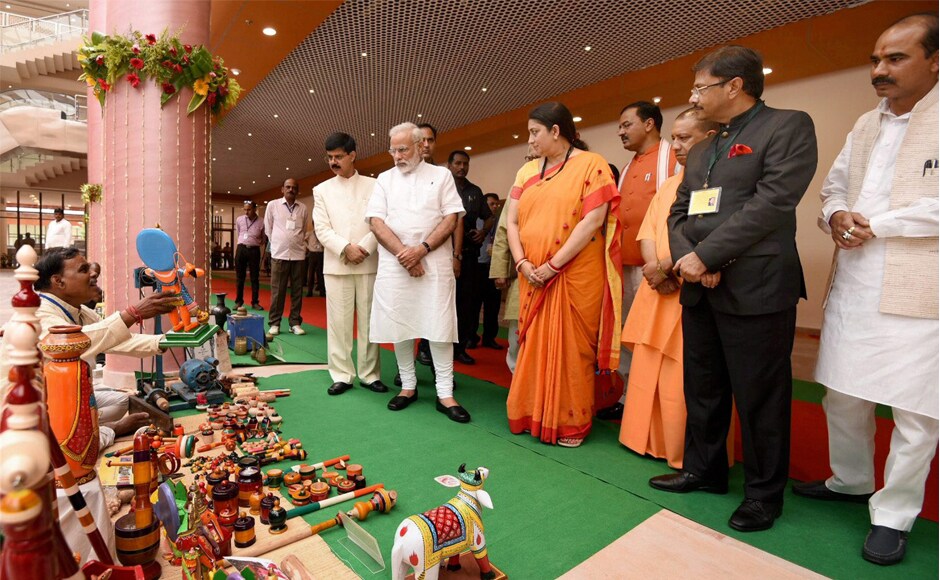 Modi interacts with the artisans at the Deendayal Hastkala Sankul in Varanasi on Friday. PTI Modi interacts with the artisans at the Deendayal Hastkala Sankul in Varanasi on Friday. PTI