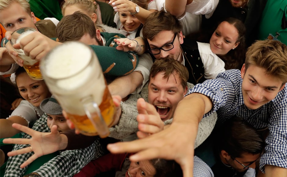 Youngsters reach out for more beer on the opening day of the 184th Oktoberfest festival in Munich, Germany, on Saturday. The world's largest beer festival will be held from 16 September to 3 October. AP Youngsters reach out for more beer on the opening day of the 184th Oktoberfest festival in Munich, Germany, on Saturday. The world's largest beer festival will be held from 16 September to 3 October. AP