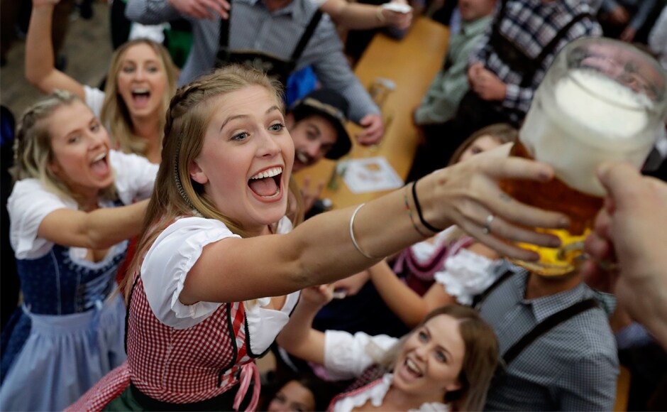 A young woman celebrates with more beer in Munich. About six million visitors are expected to throng Munich for the 184th Oktoberfest. AP A young woman celebrates with more beer in Munich. About six million visitors are expected to throng Munich for the 184th Oktoberfest. AP