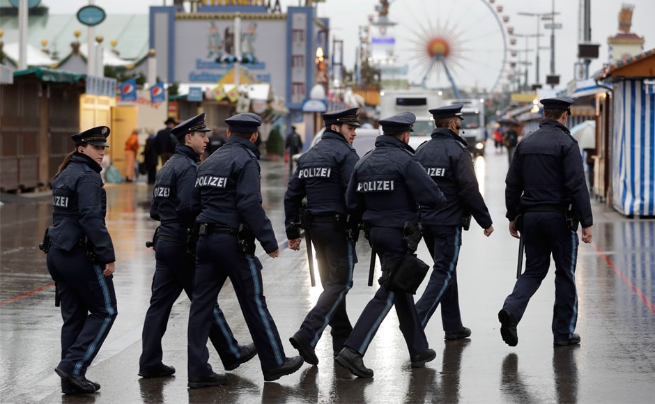 Police officers conduct patrolling during heavy rain prior to the opening of Oktoberfest. Revelers also faced increased security precautions due to possible attacks. AP Police officers conduct patrolling during heavy rain prior to the opening of Oktoberfest. Revelers also faced increased security precautions due to possible attacks. AP