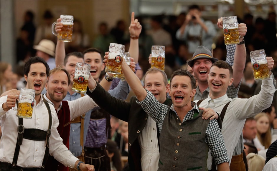 People celebrate at the beer festival in Munich. Crowds and bands often burst into <em>Ein Prosit der Gemütlichkeit</em>, a song considered the Oktoberfest anthem, which translates to 'A toast to cheer and good times'. AP People celebrate at the beer festival in Munich. Crowds and bands often burst into <em>Ein Prosit der Gemütlichkeit</em>, a song considered the Oktoberfest anthem, which translates to 'A toast to cheer and good times'. AP