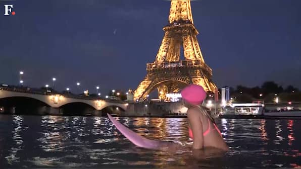 Watch: Surfing eco-warrior takes dip under Paris's Eiffel Tower
