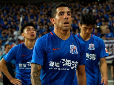 Shanghai Shenhua's Carlos Tevez walks to stands after losing the 2017 Chinese Super League football match between Shanghai East Asia (SIPG) FC and Shanghai Shenhua in Shanghai. AFP