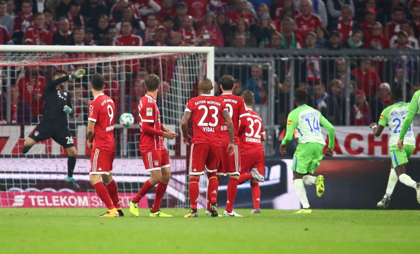 Soccer Football - Bundesliga - FC Bayern Munich vs VfL Wolfsburg - Allianz Arena, Munich, Germany - September 22, 2017 Wolfsburg's Maximilian Arnold scores their first goal from a free kick as Bayern Munich's Sven Ulreich attempts to make a save REUTERS/Michael Dalder DFL RULES TO LIMIT THE ONLINE USAGE DURING MATCH TIME TO 15 PICTURES PER GAME. IMAGE SEQUENCES TO SIMULATE VIDEO IS NOT ALLOWED AT ANY TIME. FOR FURTHER QUERIES PLEASE CONTACT DFL DIRECTLY AT + 49 69 650050 - RC196F4309F0