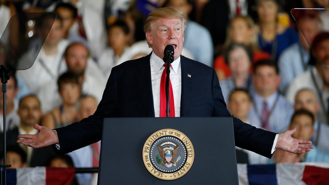 President Donald Trump gestures during a speech aboard the nuclear aircraft carrier USS Gerald R. Ford for it's commissioning at Naval Station Norfolk in Norfolk, Va., Saturday, July 22, 2017. (AP Photo/Steve Helber)