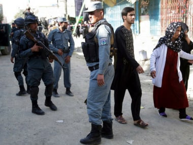 People leaving the site of the suicide attack in Kabul, Afghanistan. AP