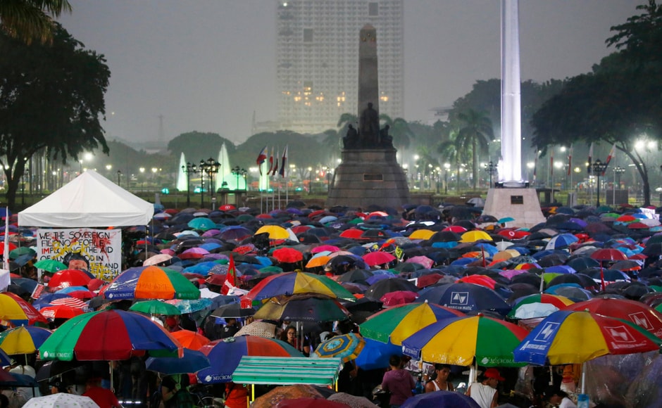 Hundreds of protesters brave the rain as they gather at the Rizal Park in Manila in a huge rally to call for an end to the killings in the so-called war on drugs of President Rodrigo Duterte as well as his alleged Hundreds of protesters brave the rain as they gather at the Rizal Park in Manila in a huge rally to call for an end to the killings in the so-called war on drugs of President Rodrigo Duterte as well as his alleged