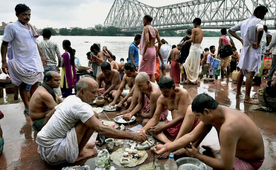 On the occasion of Mahalaya, devotees perform 'Pind Daan' during traditional Hindu ritual of 'tarpan', for the peace of the souls of ancestors, on the banks of the River Ganga near the Howrah Bridge in Kolkata on Tuesday. Celebrated a week before the five-day Durga Puja begins, Mahalaya essentially heralds the homecoming of the goddess. PTI On the occasion of Mahalaya, devotees perform 'Pind Daan' during traditional Hindu ritual of 'tarpan', for the peace of the souls of ancestors, on the banks of the River Ganga near the Howrah Bridge in Kolkata on Tuesday. Celebrated a week before the five-day Durga Puja begins, Mahalaya essentially heralds the homecoming of the goddess. PTI