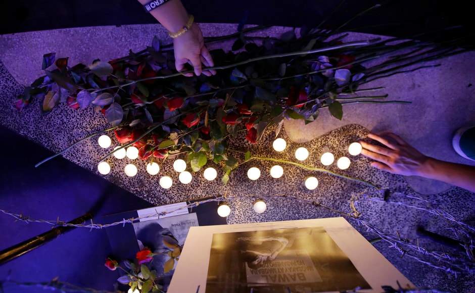 Protesters place flowers and candles under a picture of a victim of alleged extra judicial killing after a mass at the University of the Philippines Church of the Holy Sacrifice to commemorate the 45th anniversary of the imposition of martial law by the late Philippine dictator Ferdinand Marcos in metropolitan Manila, the Philippines on Thursday. AP Protesters place flowers and candles under a picture of a victim of alleged extra judicial killing after a mass at the University of the Philippines Church of the Holy Sacrifice to commemorate the 45th anniversary of the imposition of martial law by the late Philippine dictator Ferdinand Marcos in metropolitan Manila, the Philippines on Thursday. AP