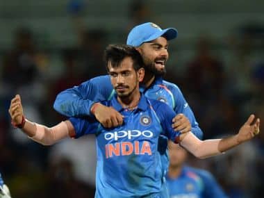 Yuzuvendra Chahal celebrates an Australian wicket with Virat Kohli during the 1st ODI in Chennai. AFP