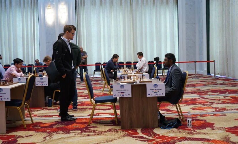 Magnus Carlsen (L) watches B Adhiban in action, Amruta Mokal