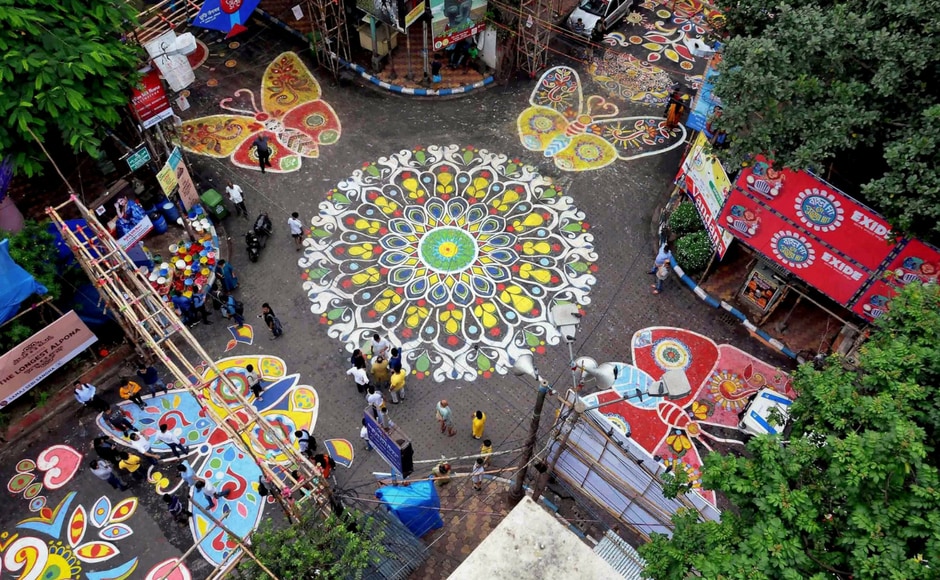 A top view during the unveiling of a kilometre long street 'Alpona' (sacred art painting) to celebrate the upcoming Durga Puja festival in Kolkata on Tuesday. Mahalaya signifies the end of Pitri Paksha (the period when Hindus pay homage to their ancestors) and the beginning of Debi Paksha (period of the goddess). PTI A top view during the unveiling of a kilometre long street 'Alpona' (sacred art painting) to celebrate the upcoming Durga Puja festival in Kolkata on Tuesday. Mahalaya signifies the end of Pitri Paksha (the period when Hindus pay homage to their ancestors) and the beginning of Debi Paksha (period of the goddess). PTI