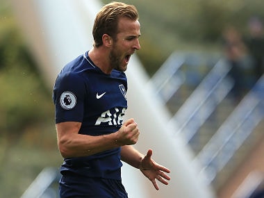 Tottenham Hotspur's English striker Harry Kane celebrates after scoring their third goal, his second, during the English Premier League football match between Huddersfield Town and Tottenham Hotspur at the John Smith's stadium in Huddersfield, northern England on September 30, 2017. / AFP PHOTO / Lindsey PARNABY / RESTRICTED TO EDITORIAL USE. No use with unauthorized audio, video, data, fixture lists, club/league logos or 'live' services. Online in-match use limited to 75 images, no video emulation. No use in betting, games or single club/league/player publications. /