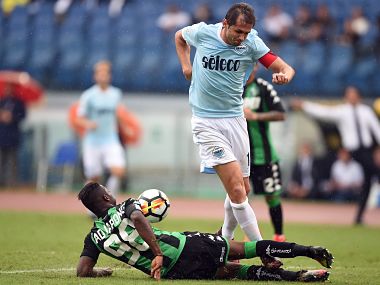 Lazio's midfielder from Bosnia-Herzegovina Senad Lulic contest with Sassuolo defender Claud Adjapong during the Italian Serie A football match. AFP