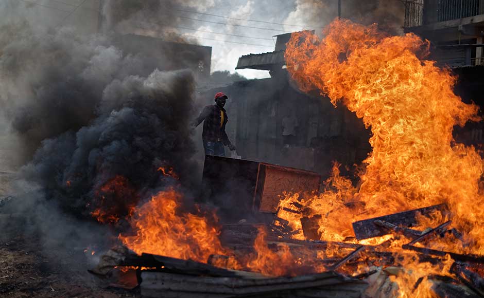 Kenya delays poll in opposition strongholds as clashes continue between police and protesters Kenya delays poll in opposition strongholds as clashes continue between police and protesters