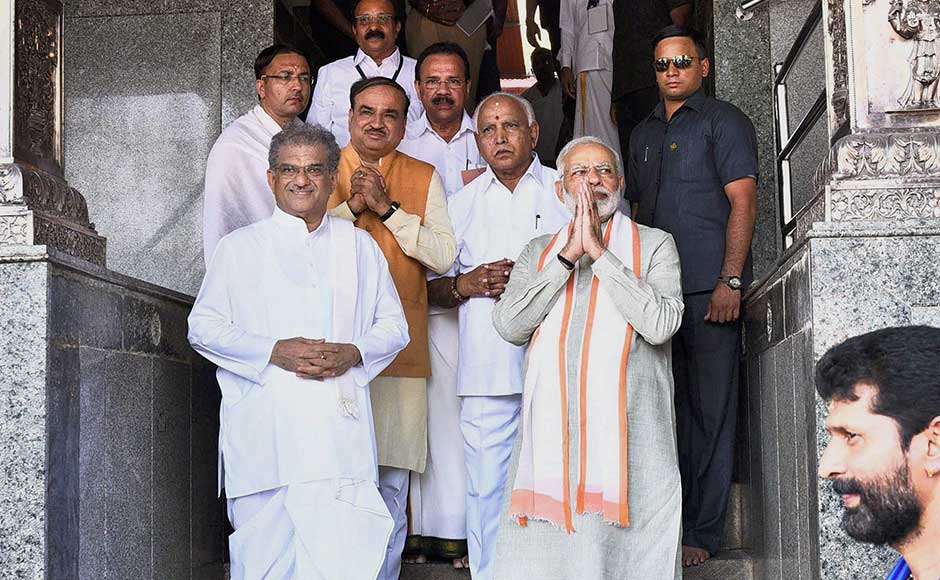 Modi’s first leg of the visit was at Dharmastahla in Dakshina Kannada district to offer prayers to Hindu god Shiva at the Manjunatheshwara temple. Union Ministers DV Sadananda Gowda and Ananth Kumar, BS Yeddyurappa and other dignitaries are seen along with Modi. PIB Modi’s first leg of the visit was at Dharmastahla in Dakshina Kannada district to offer prayers to Hindu god Shiva at the Manjunatheshwara temple. Union Ministers DV Sadananda Gowda and Ananth Kumar, BS Yeddyurappa and other dignitaries are seen along with Modi. PIB