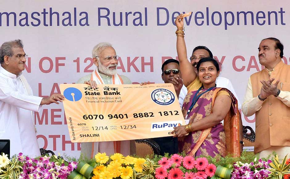 The prime minister then addressed a public rally at Ujire, a small town near the west coast, near Dharmasthala. He also handed over RuPay cards to some Pradhan Mantri Jan Dhan Yojana (PMJDY) account holders. PIB The prime minister then addressed a public rally at Ujire, a small town near the west coast, near Dharmasthala. He also handed over RuPay cards to some Pradhan Mantri Jan Dhan Yojana (PMJDY) account holders. PIB