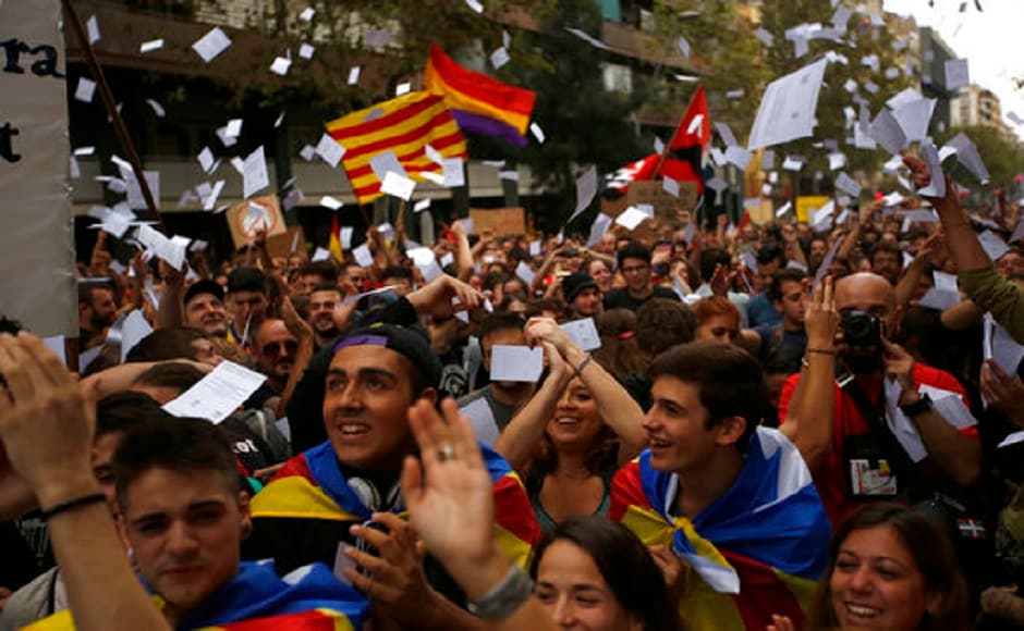 Demonstrators throw referendum ballots in the air as they rally in front of the Spanish Partido Popular ruling party headquarters in Barcelona, Spain. AP Demonstrators throw referendum ballots in the air as they rally in front of the Spanish Partido Popular ruling party headquarters in Barcelona, Spain. AP