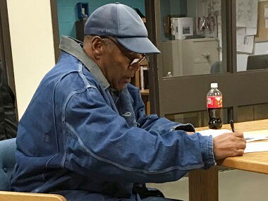 Former football legend O.J. Simpson signs documents at the Lovelock Correctional Center, Saturday, Sept. 30, 2017, in Lovelock, Nev. Simpson was released from the Lovelock Correctional Center in northern Nevada early Sunday, Oct. 1, 2017. (Brooke Keast/Nevada Department of Corrections via AP)