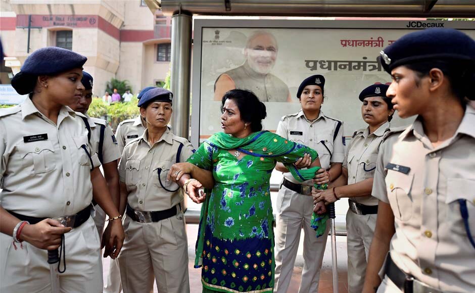 Police apprehend a Delhi BJP woman worker during the rally outside the CPM office in New Delhi on Monday. PTI Police apprehend a Delhi BJP woman worker during the rally outside the CPM office in New Delhi on Monday. PTI