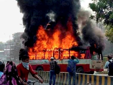 File image of angry supporters setting ablaze a bus during a protest against the murder of BSP leader Rajesh Yadav, in Allahabad on Tuesday. PTI