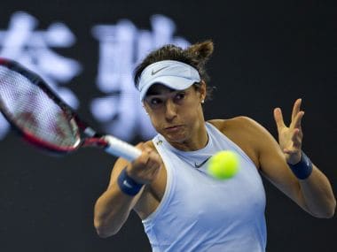 Caroline Garcia of France returns a shot to Elina Svitolina of Ukraine during a women's singles quarterfinal match in the China Open tennis tournament held at the Diamond Court in Beijing, China, Friday, Oct. 6, 2017. (AP Photo/Ng Han Guan)