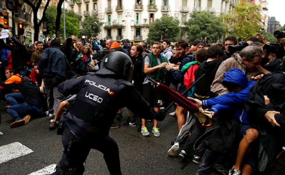 Riot police forced their way into polling stations in the Catalan town of Girona on sunday where the region's separatist leader was due to vote banned by Madrid. AP Riot police forced their way into polling stations in the Catalan town of Girona on sunday where the region's separatist leader was due to vote banned by Madrid. AP