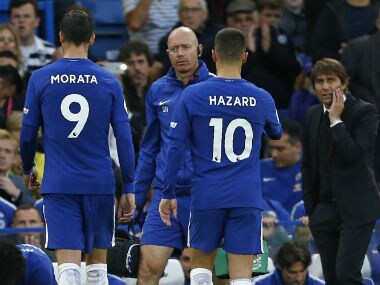 Antonio Conte (R) looks on as Chelsea's Spanish striker Alvaro Morata leaves the pitch injured. AFP