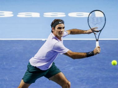 Roger Federer returns a ball to USA's Frances Tiafoe during their first round match at the Swiss Indoors tennis tournament at the St. Jakobshalle in Basel, Switzerland. AP