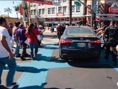 Car drives through marchers at California immigrant rights rally, police says no foul play suspected
