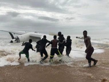 People pull the wreckage of a propeller-engine cargo plane after it crashed in the sea near the international airport in Ivory Coast's main city, Abidjan. Reuters