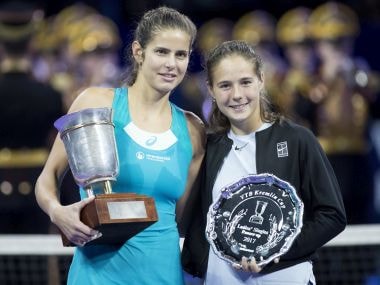 Julia Goerges of Germany poses with the trophy after defeating Daria Kasatkina of Russia, right, in the final match at the Kremlin Cup tennis tournament in Moscow, Russia, Saturday, Oct. 21, 2017. (AP Photo/Pavel Golovkin)