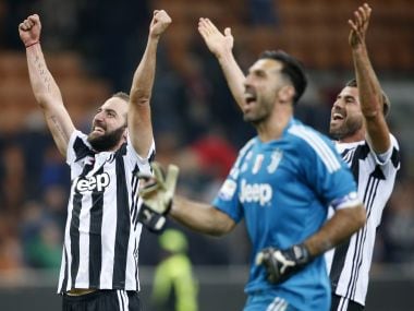 Juventus' Gonzalo Higuain, left, celebrates their win over AC Milan with teammates. AP
